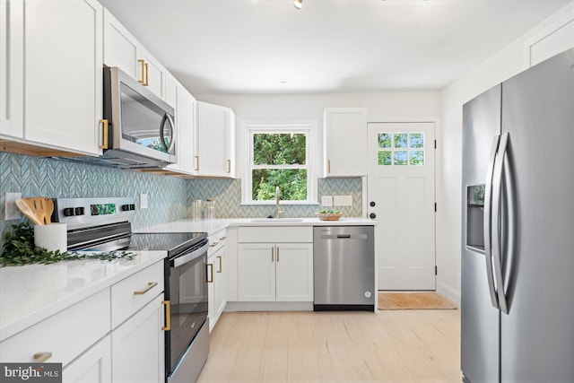 3402 Stevenswood Ct, Baltimore, MD 21244 - kitchen with appliances with stainless steel finishes, plenty of natural light, decorative backsplash, and white cabinetry