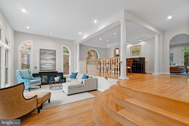 3929 Vacation Ln, Arlington, VA 22207 - living room with ornate columns, wood finished floors, recessed lighting, and arched walkways