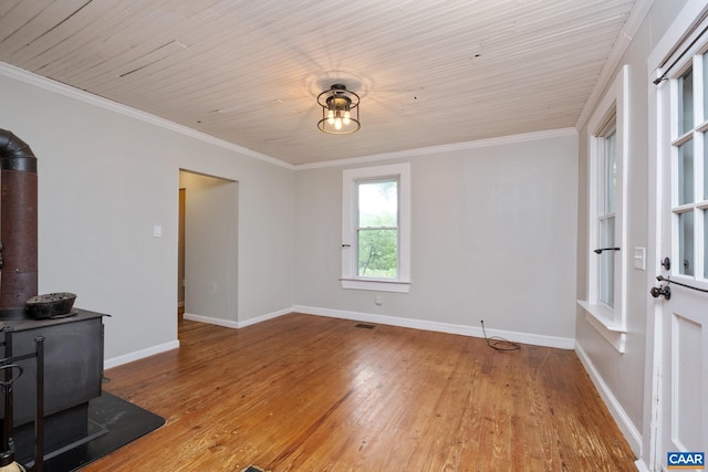 343 Burnt Tree Way, Orange, VA 22960 - empty room with a wood stove, light wood finished floors, and crown molding