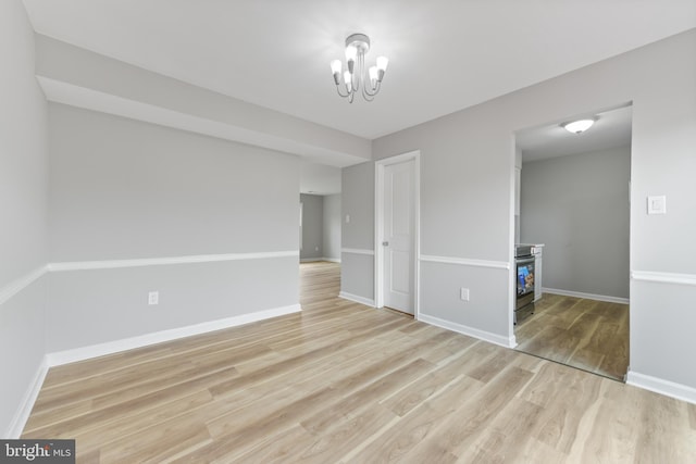 8995 Patterson Pl, Manassas, VA 20110 - empty room with light wood-style flooring and a chandelier