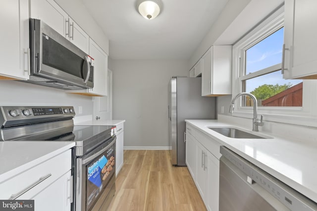 8995 Patterson Pl, Manassas, VA 20110 - kitchen featuring appliances with stainless steel finishes, light wood-type flooring, white cabinetry, and light countertops