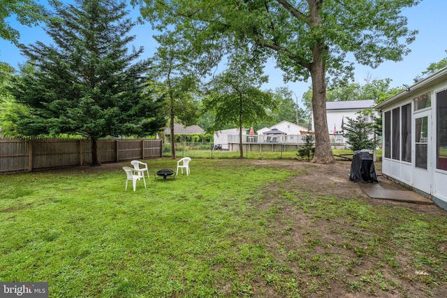 3519 Sunset Ave, Williamstown, NJ 08094 - fenced backyard with an outdoor fire pit and a sunroom