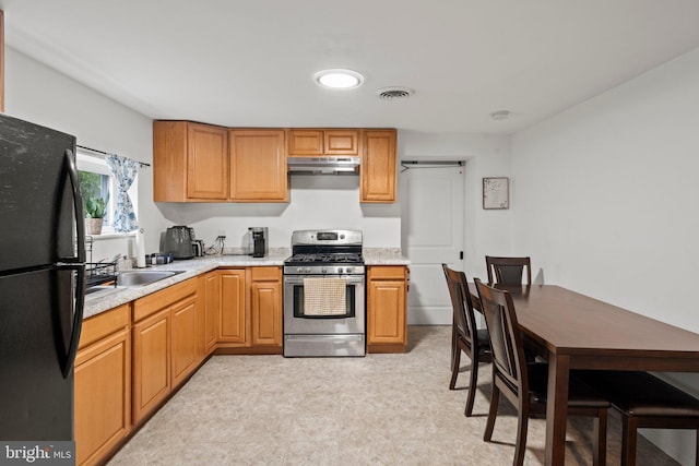 3519 Sunset Ave, Williamstown, NJ 08094 - kitchen featuring freestanding refrigerator, stainless steel range with gas cooktop, under cabinet range hood, and light floors