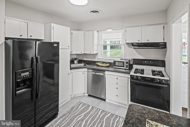 8328 Merrymount Dr, Baltimore, MD 21244 - kitchen featuring stainless steel appliances, under cabinet range hood, white cabinets, dark countertops, and light tile patterned flooring
