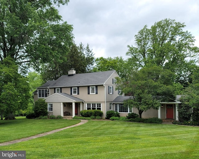 2424 Stanwick Rd, Phoenix, MD 21131 - view of front of house with a front lawn, a chimney, and roof with shingles