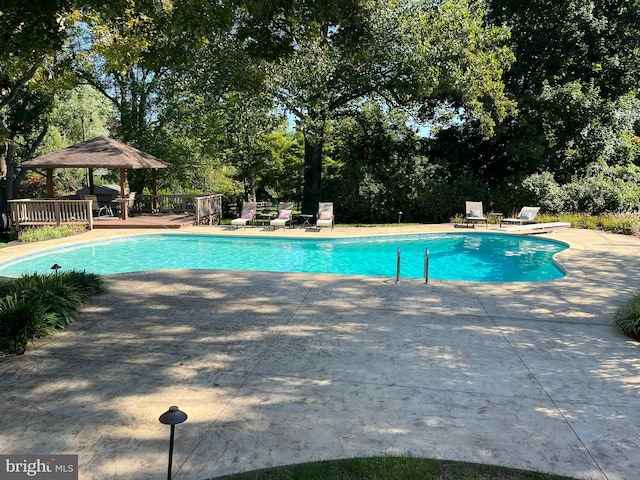 2424 Stanwick Rd, Phoenix, MD 21131 - view of swimming pool with a gazebo, view of scattered trees, a patio area, and a deck