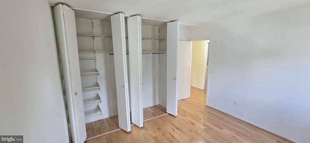 350 Juniper Ct, Herndon, VA 20170 - unfurnished bedroom with light wood-style floors and multiple closets