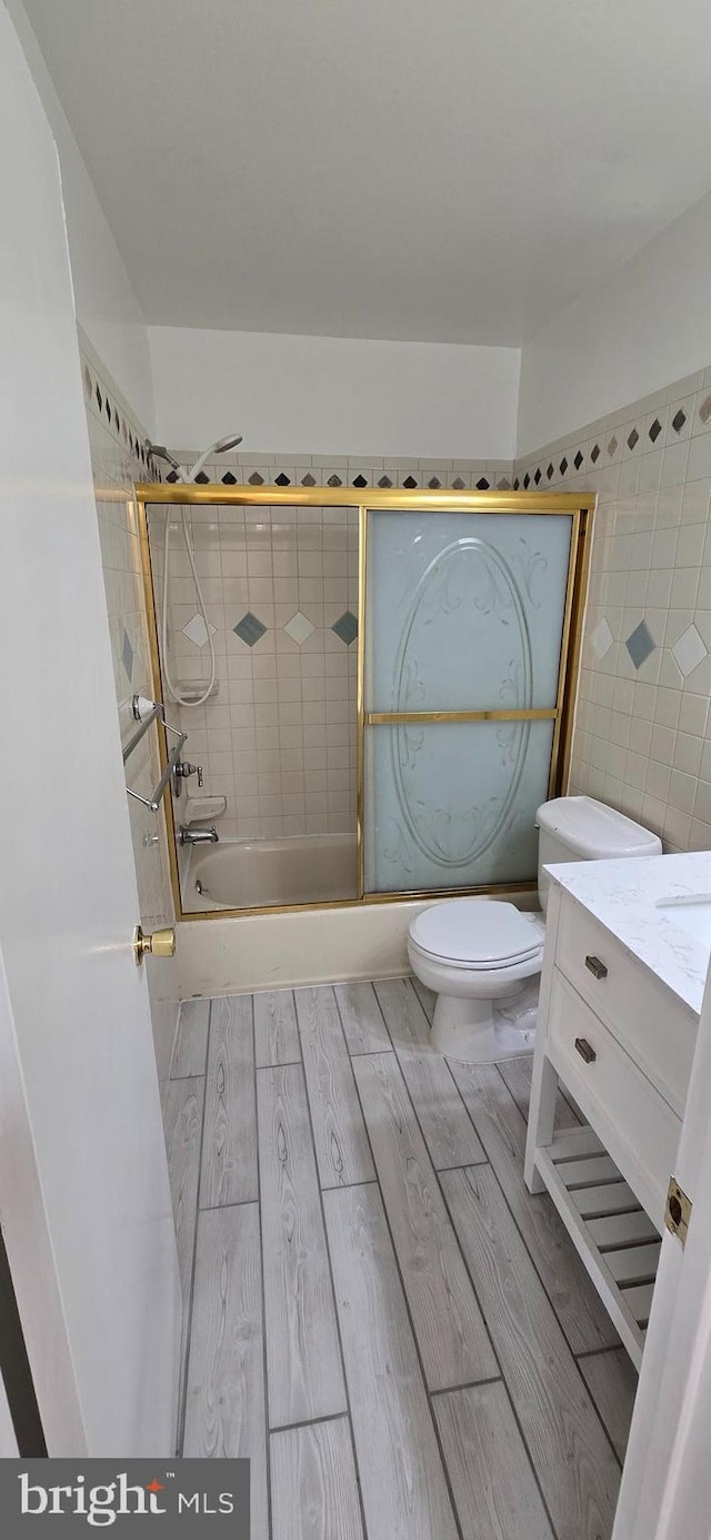 350 Juniper Ct, Herndon, VA 20170 - full bath featuring wood finished floors, bath / shower combo with glass door, and vanity