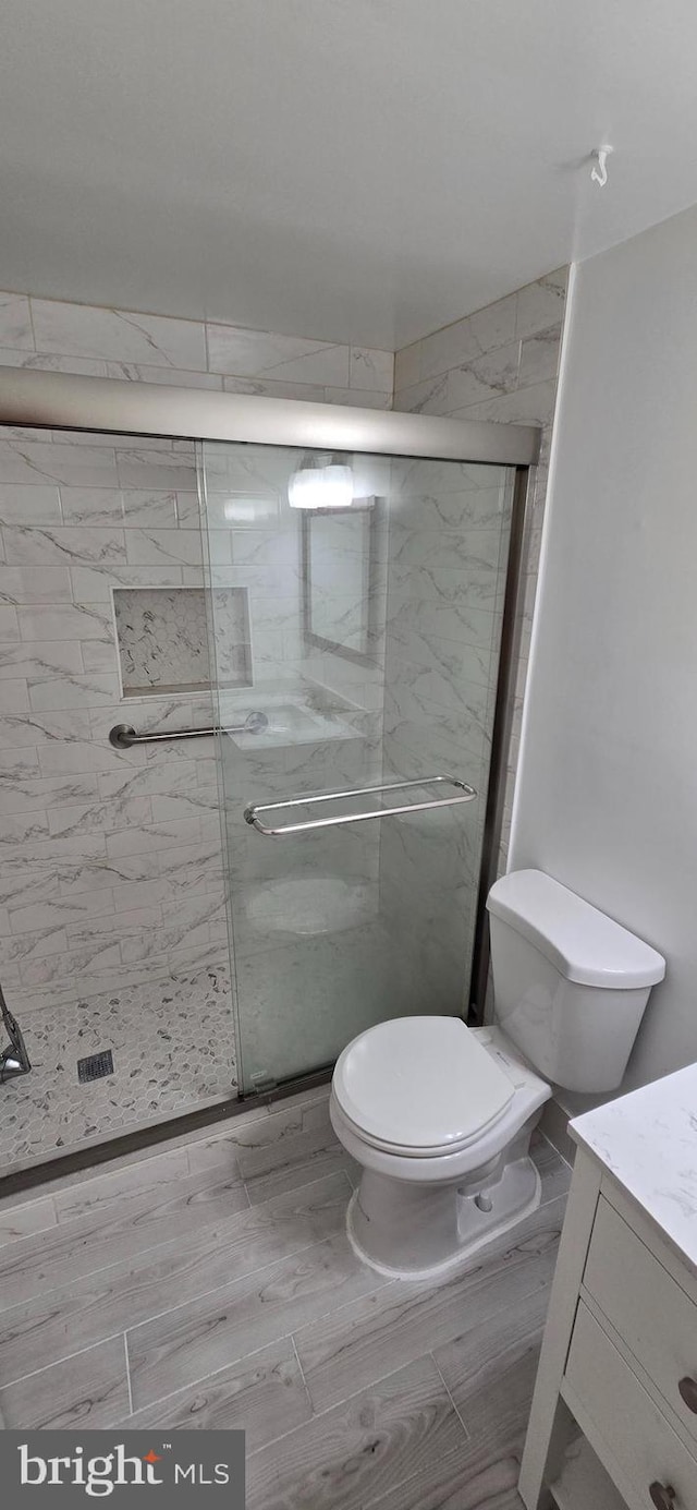350 Juniper Ct, Herndon, VA 20170 - bathroom featuring vanity, a stall shower, and wood finished floors