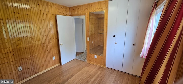 350 Juniper Ct, Herndon, VA 20170 - unfurnished bedroom with light wood-style floors, wood walls, and a closet