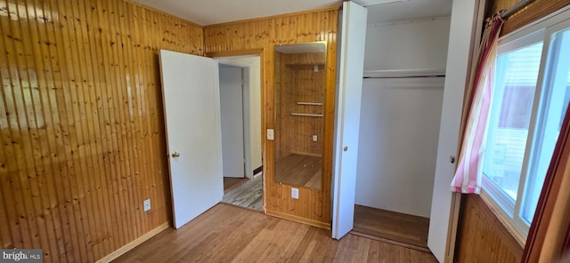 350 Juniper Ct, Herndon, VA 20170 - unfurnished bedroom featuring wood finished floors, wood walls, a closet, and multiple windows