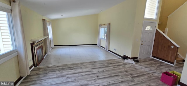 350 Juniper Ct, Herndon, VA 20170 - unfurnished living room featuring healthy amount of natural light, wood finished floors, stairs, and high vaulted ceiling