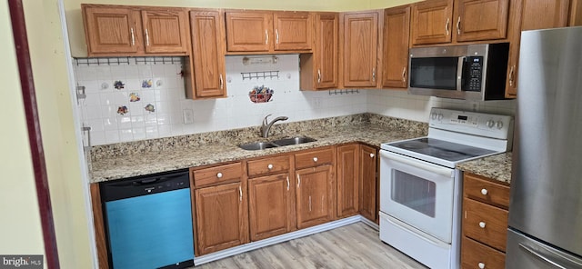 350 Juniper Ct, Herndon, VA 20170 - kitchen with stainless steel appliances, brown cabinets, and light stone counters