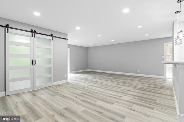 2 Stonehenge Cir Unit 2A-2, Baltimore, MD 21208 - unfurnished room featuring a barn door, recessed lighting, and light wood finished floors