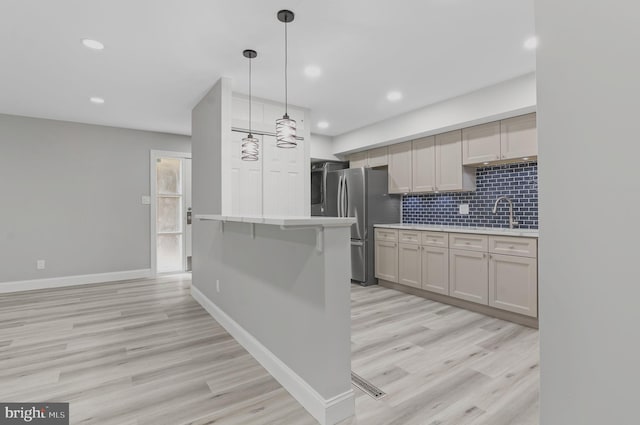 2 Stonehenge Cir Unit 2A-2, Baltimore, MD 21208 - kitchen with light countertops, light wood-type flooring, recessed lighting, tasteful backsplash, and freestanding refrigerator