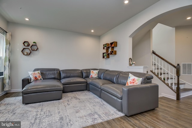 6647 Ballenger Run Blvd, Frederick, MD 21703 - living area with arched walkways, wood finished floors, stairway, and recessed lighting