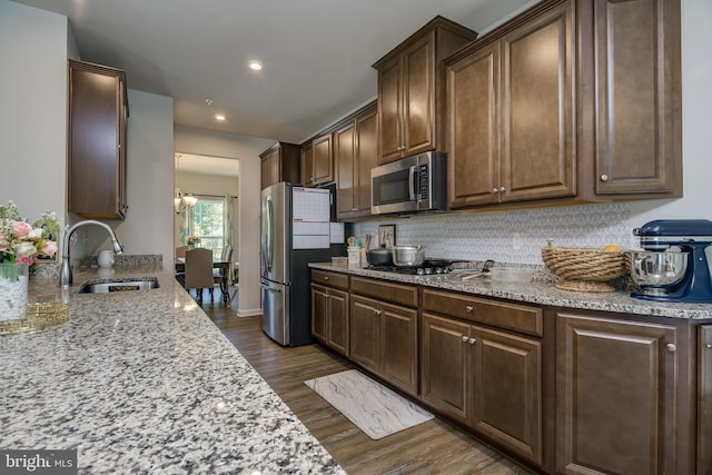 6647 Ballenger Run Blvd, Frederick, MD 21703 - kitchen with stainless steel appliances, dark wood-style floors, light stone counters, decorative backsplash, and recessed lighting