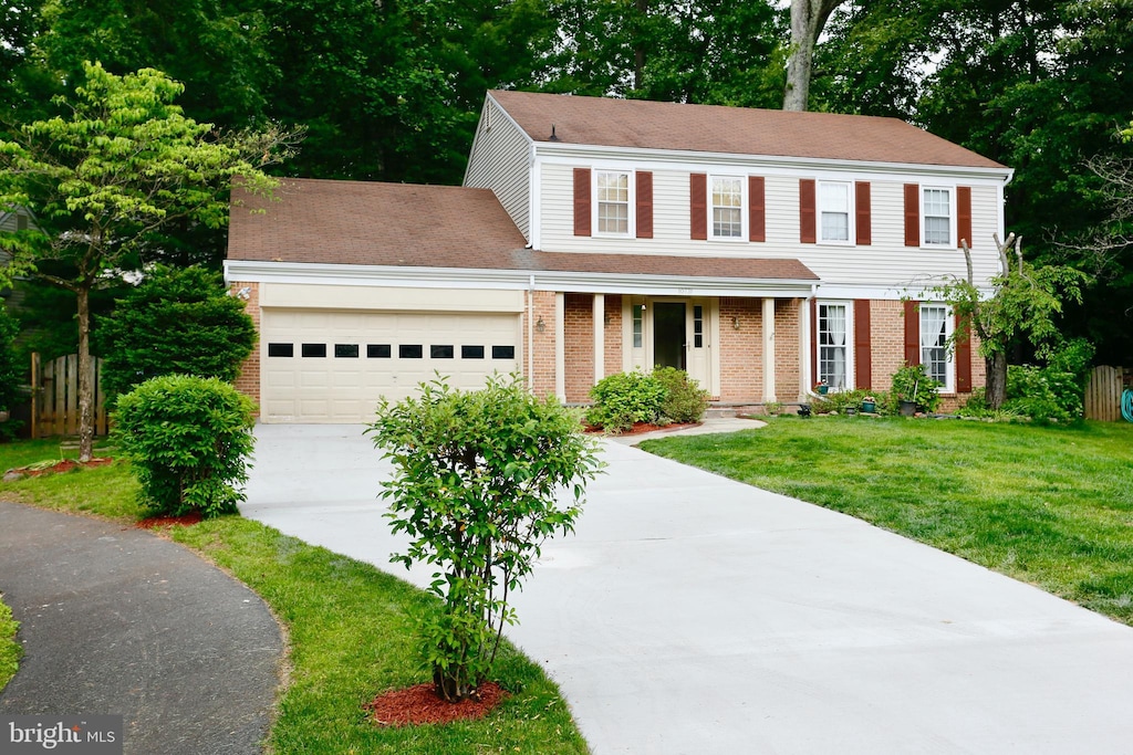 10731 Bear Oak Ct, Burke, VA 22015 - colonial inspired home featuring driveway, a garage, brick siding, covered porch, and roof with shingles