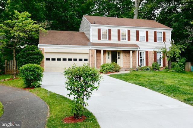 10731 Bear Oak Ct, Burke, VA 22015 - colonial inspired home featuring driveway, a garage, brick siding, covered porch, and roof with shingles