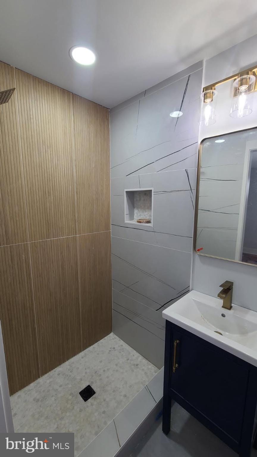 5155 8th St NE, Washington, DC 20011 - bathroom with vanity, tiled shower, and tile patterned floors
