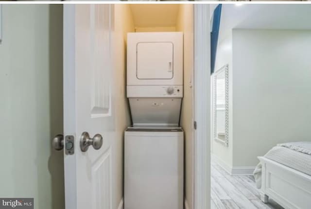 405 Ocean Ave Unit 110, Wildwood, NJ 08260 - washroom with stacked washing machine and dryer and light wood-type flooring