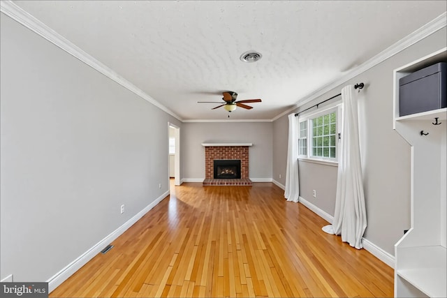 5379 Payne Dr, King George, VA 22485 - unfurnished living room with ceiling fan, light wood finished floors, ornamental molding, and a brick fireplace