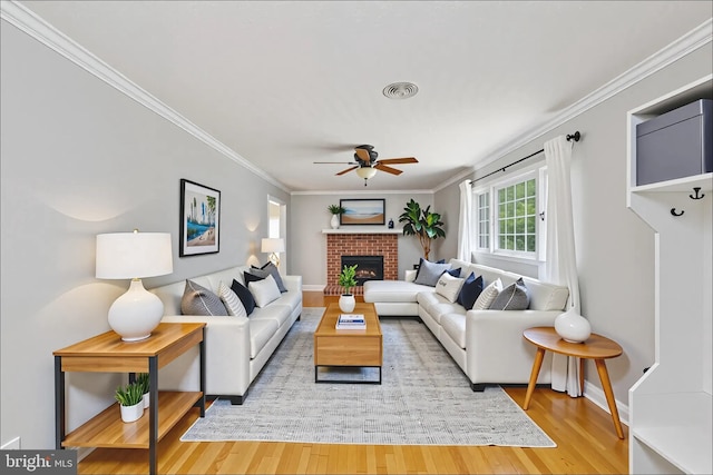 5379 Payne Dr, King George, VA 22485 - living area with ceiling fan, wood finished floors, a brick fireplace, and ornamental molding