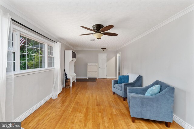 5379 Payne Dr, King George, VA 22485 - living area with light wood-style flooring, ceiling fan, and ornamental molding