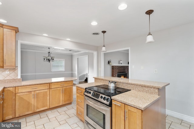 5379 Payne Dr, King George, VA 22485 - kitchen with electric range, a brick fireplace, light stone countertops, recessed lighting, and pendant lighting