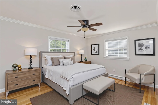 5379 Payne Dr, King George, VA 22485 - bedroom with crown molding, light wood-type flooring, a baseboard heating unit, and ceiling fan