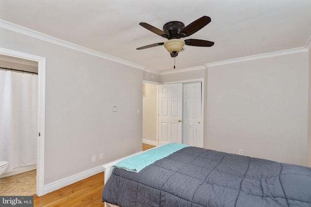 5379 Payne Dr, King George, VA 22485 - bedroom featuring ornamental molding, light wood-style floors, ceiling fan, and a closet
