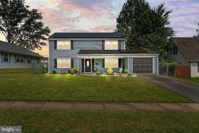 31 Mercator Ln, Willingboro, NJ 08046 - traditional-style house with a garage, asphalt driveway, solar panels, and covered porch