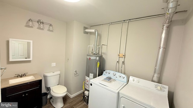 421 N Hanover St, Carlisle, PA 17013 - washroom with washer and clothes dryer, water heater, and dark wood-style flooring