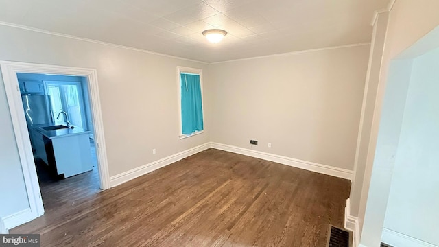 421 N Hanover St, Carlisle, PA 17013 - spare room with dark wood-type flooring and crown molding