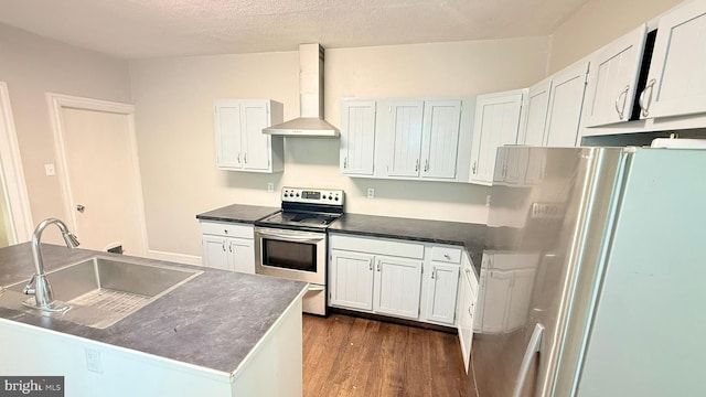 421 N Hanover St, Carlisle, PA 17013 - kitchen with freestanding refrigerator, electric stove, wall chimney exhaust hood, dark countertops, and dark wood-style flooring
