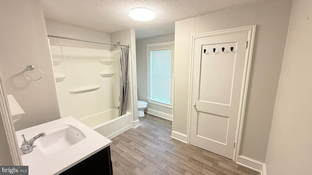 421 N Hanover St, Carlisle, PA 17013 - full bathroom with a textured ceiling, wood finished floors, shower / tub combo, and vanity
