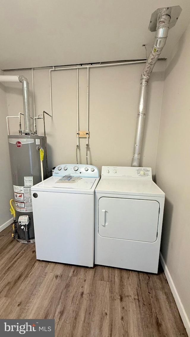 421 N Hanover St, Carlisle, PA 17013 - washroom with water heater, washing machine and dryer, and wood finished floors