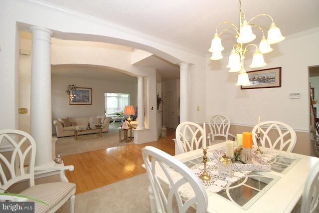 802 Chesapeake Ct, Newark, DE 19702 - dining area featuring decorative columns, arched walkways, ornamental molding, wood finished floors, and a chandelier