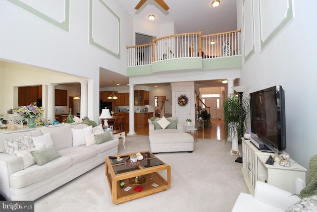 802 Chesapeake Ct, Newark, DE 19702 - carpeted living area with decorative columns, a ceiling fan, and a towering ceiling
