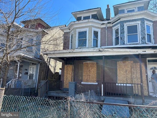 210 Highland Ave, Trenton, NJ 08618 - view of front of house featuring covered porch, a fenced front yard, and brick siding