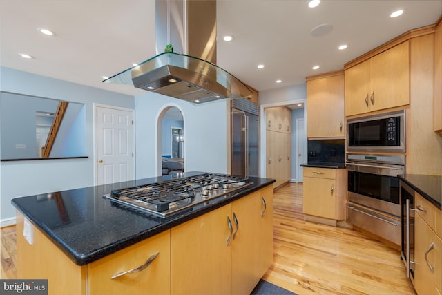 11 Forest Rdg, Newark, DE 19711 - kitchen with appliances with stainless steel finishes, island range hood, light wood-style floors, a kitchen island, and arched walkways