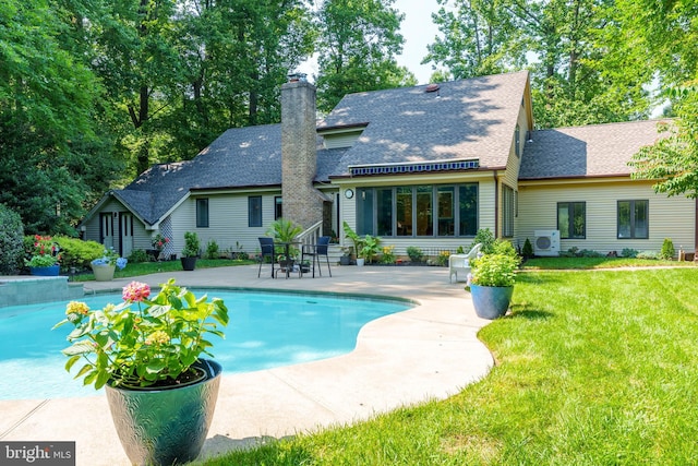 11 Forest Rdg, Newark, DE 19711 - back of house featuring a shingled roof, a patio, a lawn, and an outdoor pool
