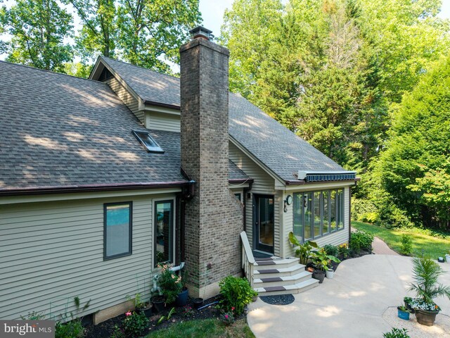 11 Forest Rdg, Newark, DE 19711 - view of front of property featuring roof with shingles, a chimney, and a patio