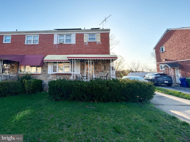 5511 Todd Ave, Baltimore, MD 21206 - townhome / multi-family property featuring stone siding and a front lawn