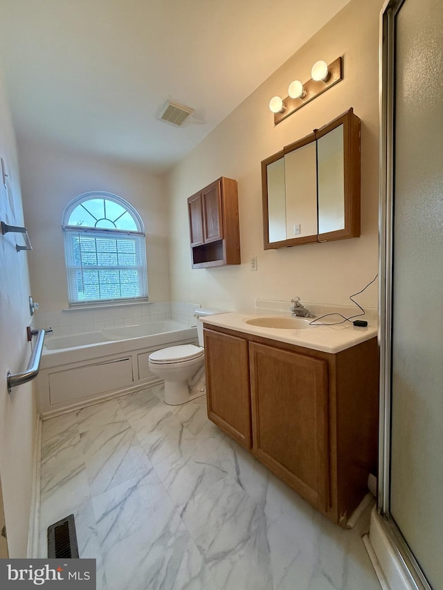 518 Leo Ct, Smyrna, DE 19977 - bathroom featuring marble look tiles, vanity, a garden tub, and a shower with shower door