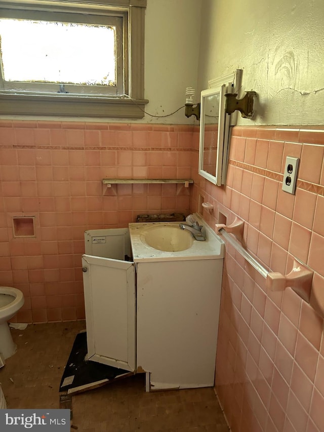 212 Highland Ave, Trenton, NJ 08618 - half bath with tile walls, vanity, and a wainscoted wall