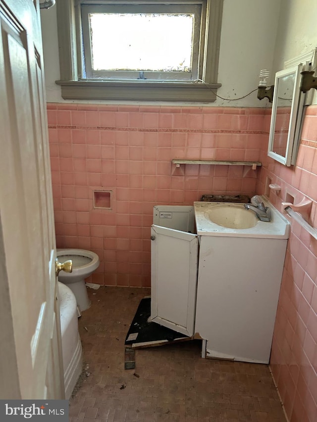 212 Highland Ave, Trenton, NJ 08618 - half bath with tile walls, vanity, healthy amount of natural light, and wainscoting