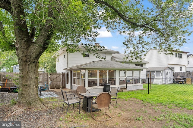 202 E Franklin Ave, Edgewater Park, NJ 08010 - back of property with a sunroom, a fire pit, a fenced backyard, and roof with shingles