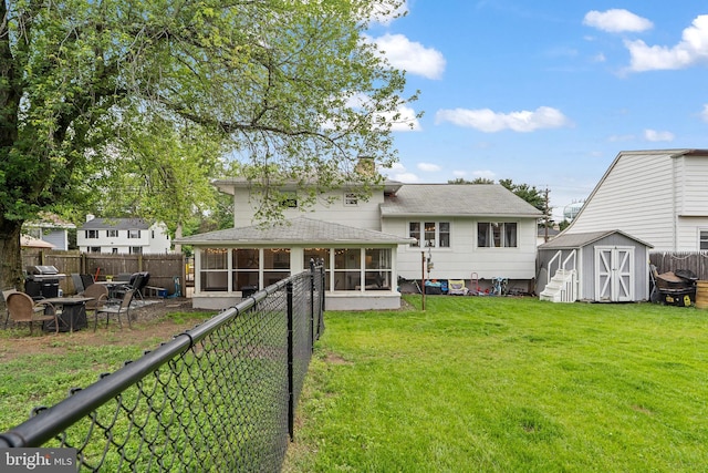 202 E Franklin Ave, Edgewater Park, NJ 08010 - back of house featuring a sunroom, a storage unit, a fenced backyard, and a shingled roof