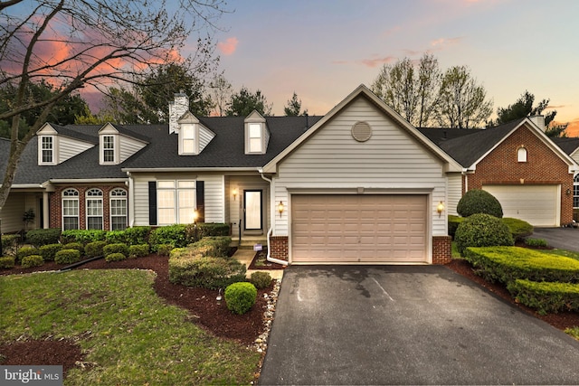 2135 Vittoria Ct Unit 33, Bowie, MD 20721 - cape cod-style house featuring asphalt driveway, brick siding, and a garage